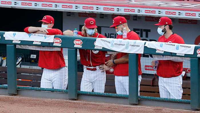 Reds players wearing masks in the dugout